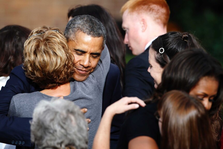 Barack and Michelle Obama hug family members of people slain in the Washington Navy Yard shooting.