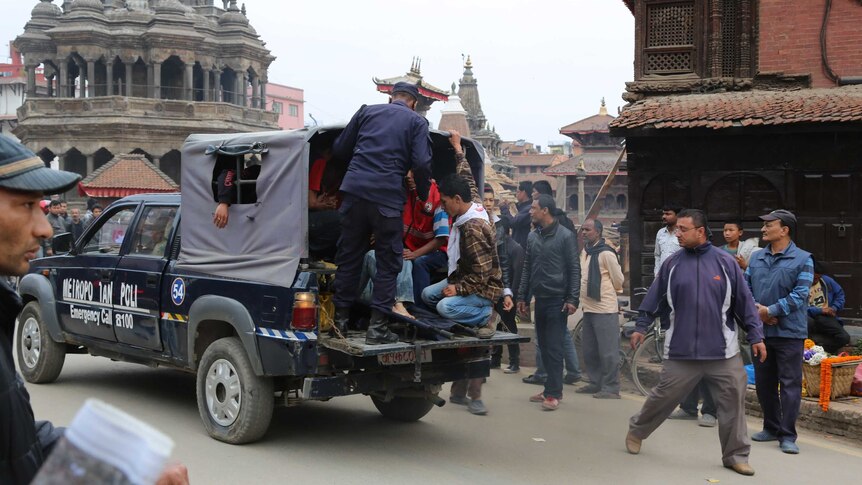 Police rescuing injured people from collapsed buildings in Nepal