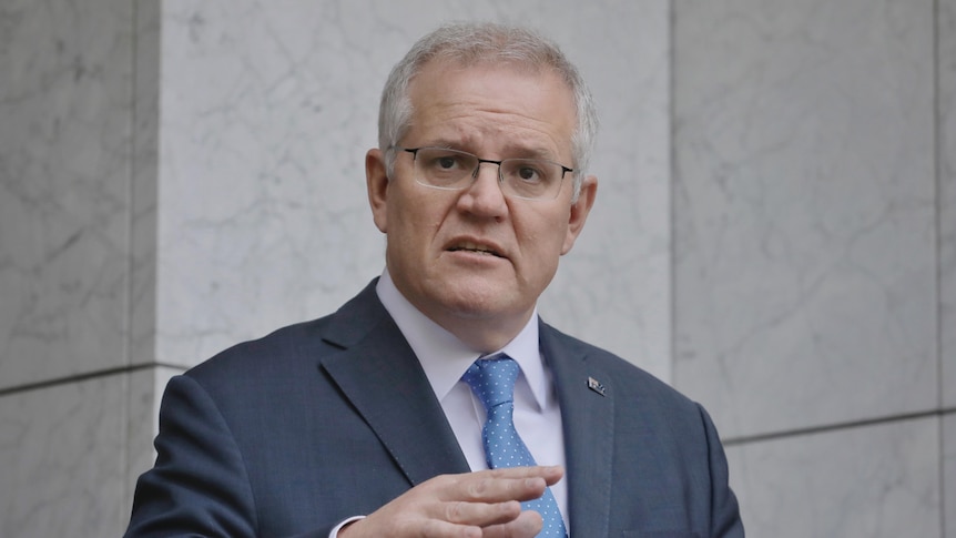 Scott Morrison looks into the distance at a press conference