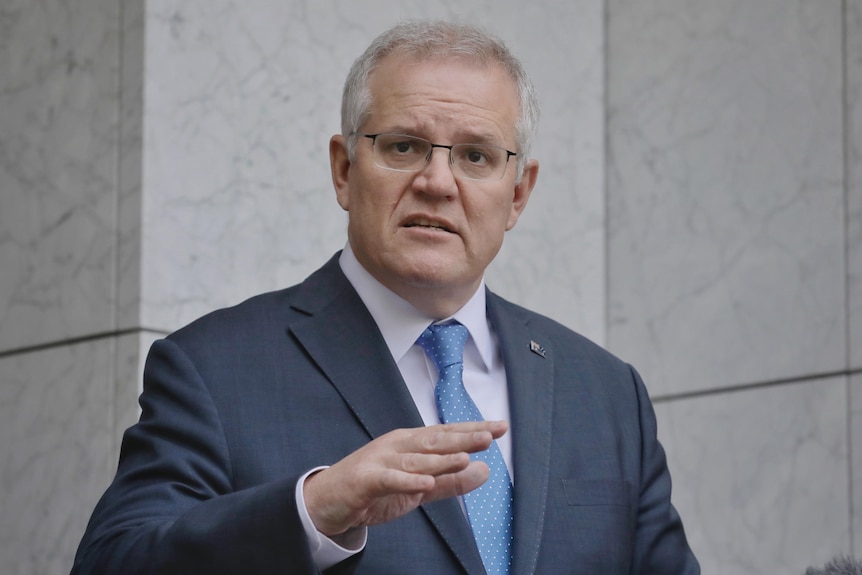 Scott Morrison looks into the distance at a press conference