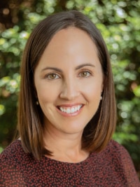 Young woman with dark hair smiling at the camera