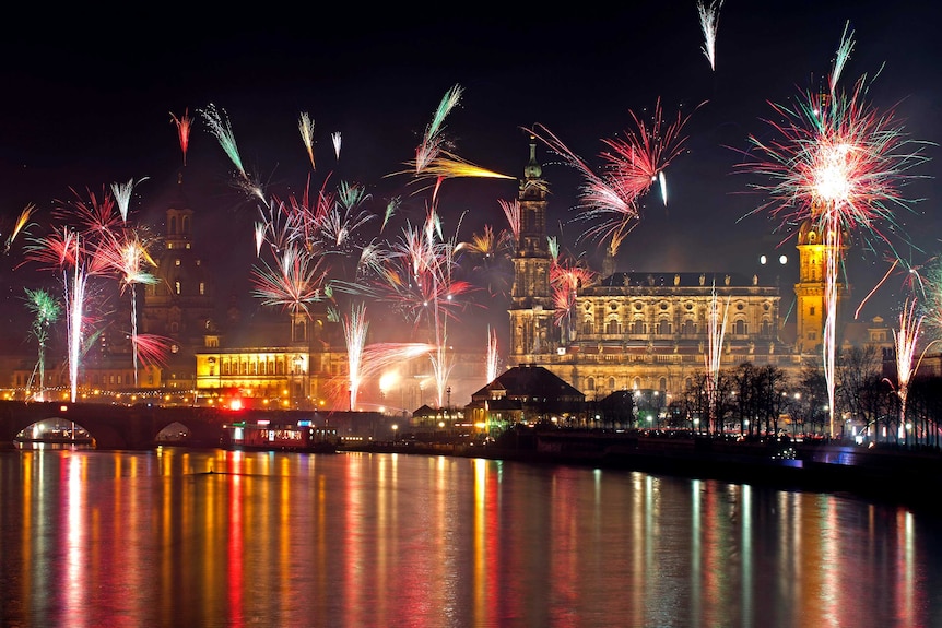Fireworks erupt over the Elbe River in Dresden.