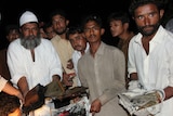 Leaders of Bharchundi shrine show burnt copies of the Koran.