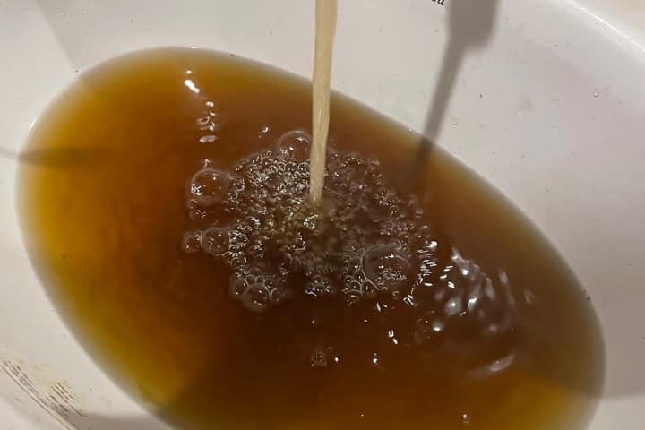 a sink of dirty, brown water