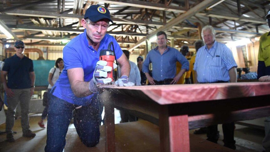 Tony Abbott sands down a table