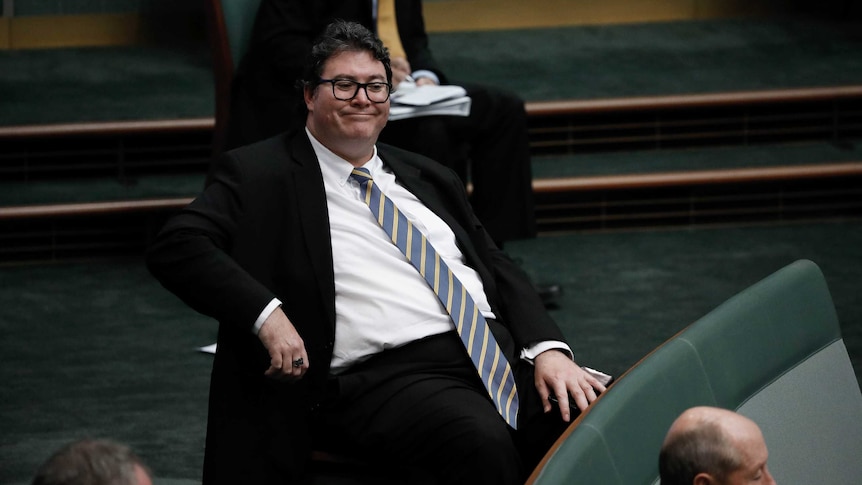 Christensen sits back in his chair, has a really long tie.