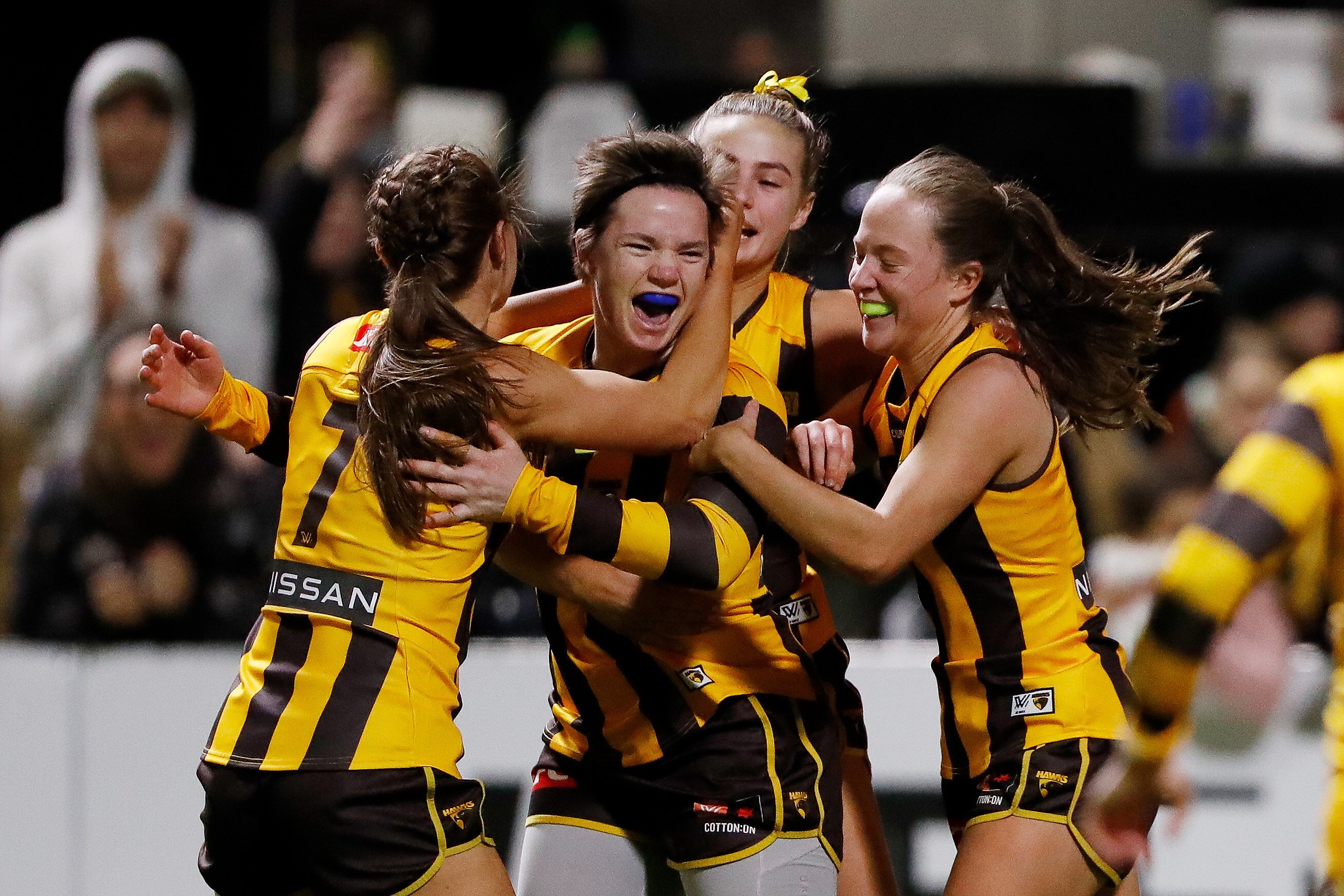 Jess Duffin is hugged by three teammates