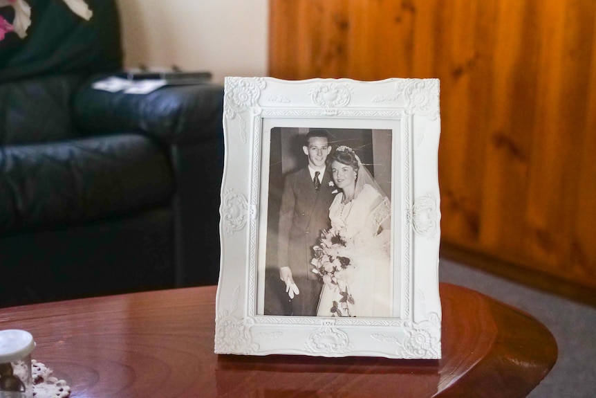  A photo of a framed wedding photo from the 1950s.