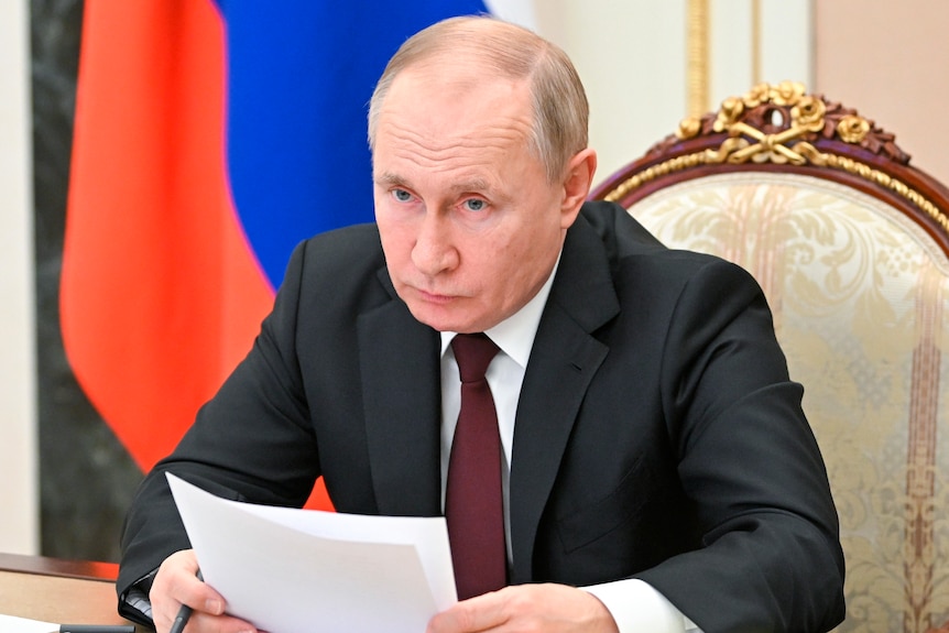 The Russian president looks serious while attending a meeting on economic issues, in Moskow