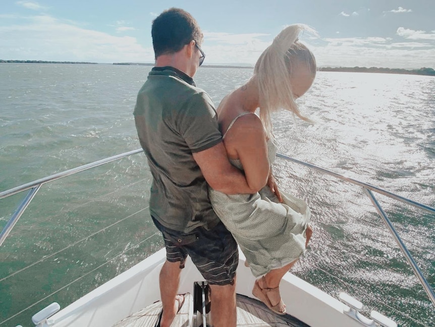 Two people on a boat hugging