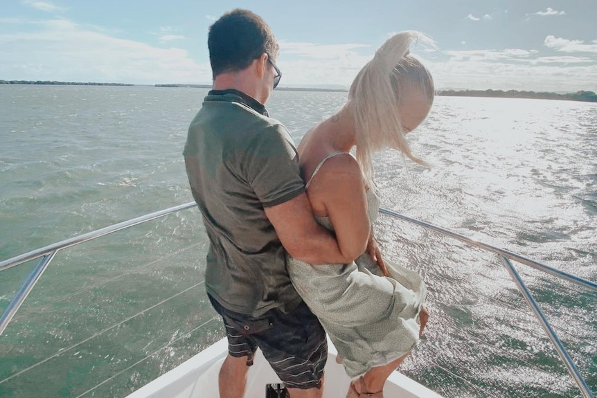 two people on a boat hugging
