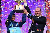 Karthik Nemmani holds up a trophy after winning the Scripps National Spelling Bee.