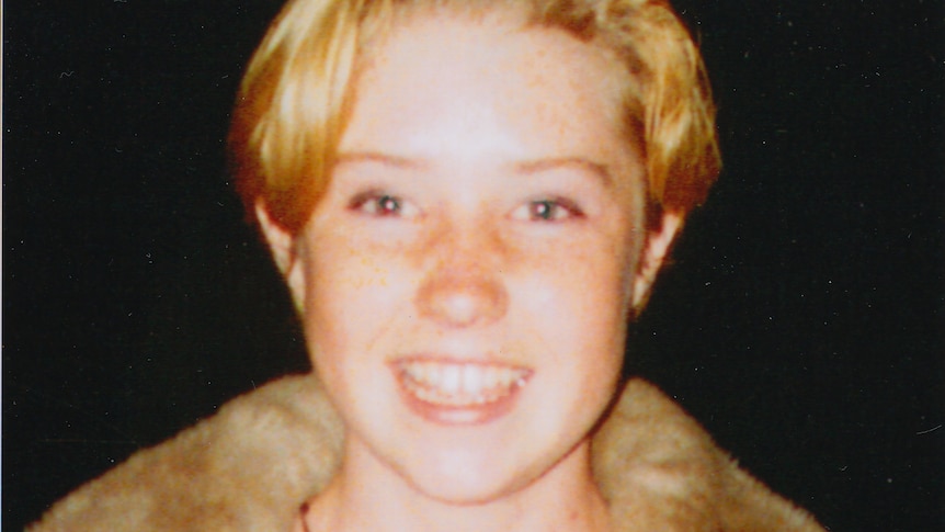 A smiling young woman with short blonde hair.