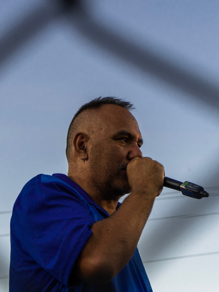 man in blue with microphone