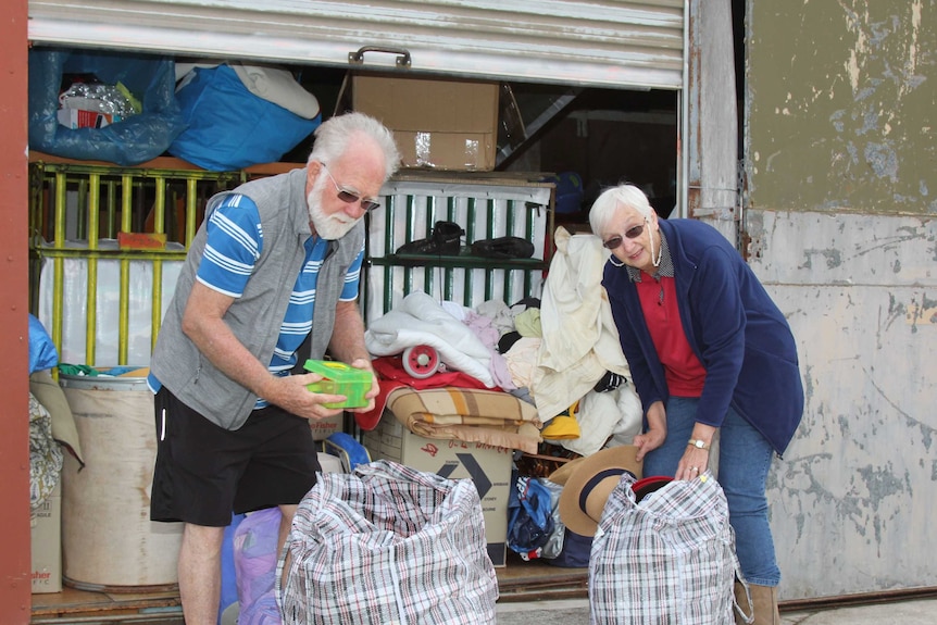 Brian and Ann Lamont sort bags of donated clothes