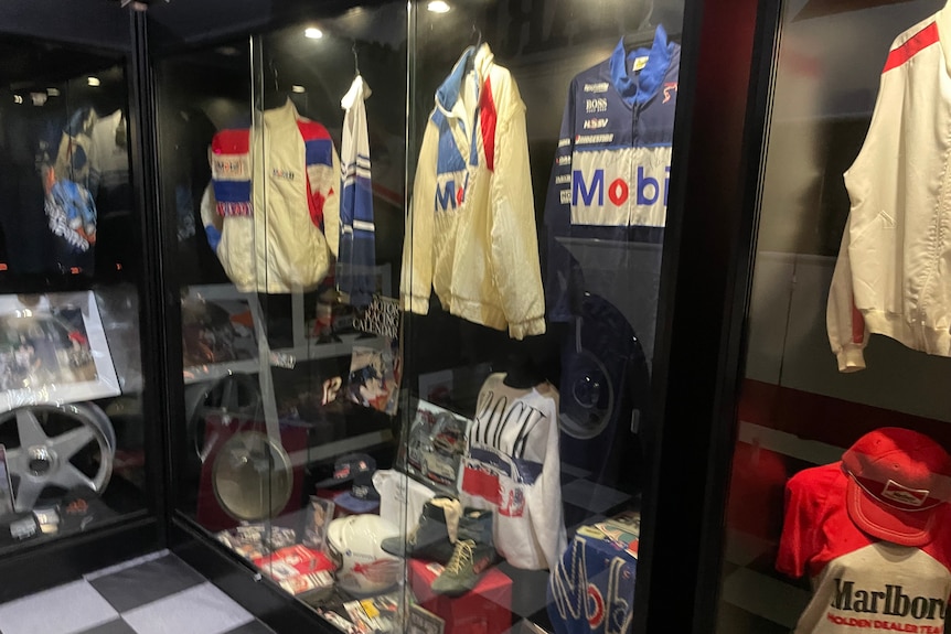 Australian race car driver Peter Brock's race suits sit in a display cabinet owned by Peter Champion.