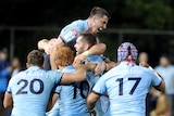 Rugby union players celebrate a victory 