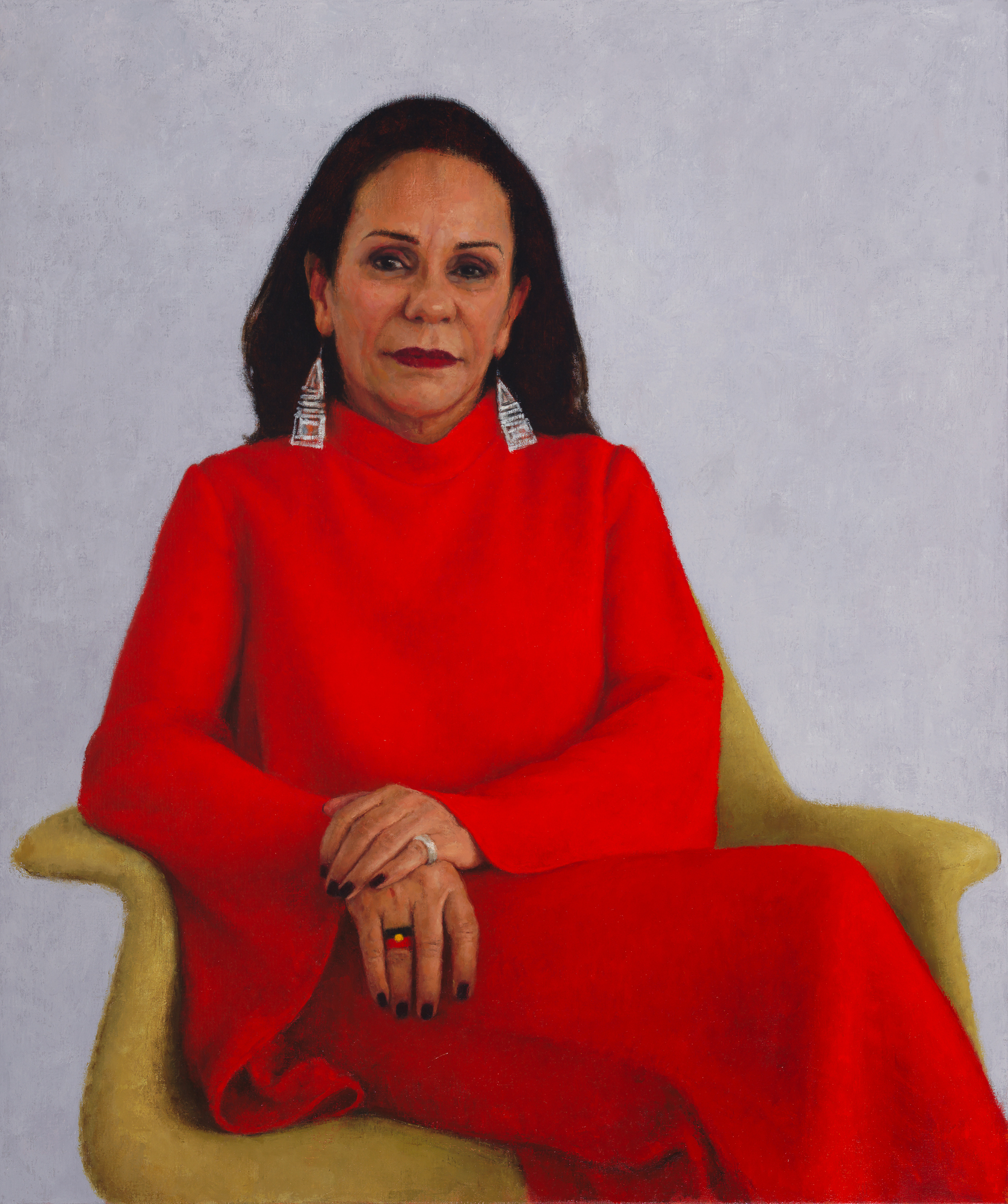 A portrait painting of Linda Burney, a Wiradjuri woman with dark hair wearing a vibrant red top and matching pant suit.