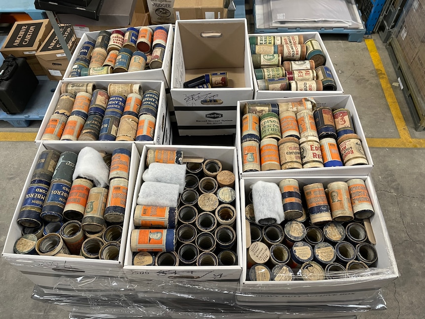 Clear containers holding old-looking cylinders.