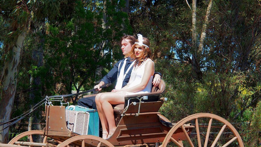 Taylor Pfeiffer in a horse-drawn buggy with male companion