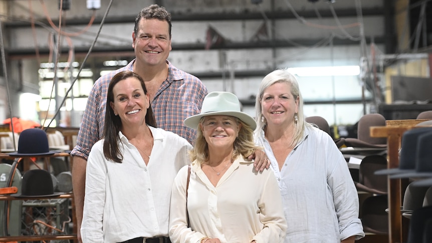 Nicola Forrest, Stephen Keir and his sisters Nikki McLeod and Stacey McIntyre stand inside the Kempsey Akubra factory.