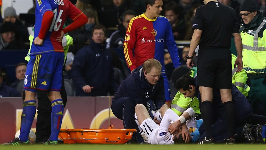 Gareth Bale from Tottenham Hotspur receives treatment for an ankle injury at White Hart Lane.