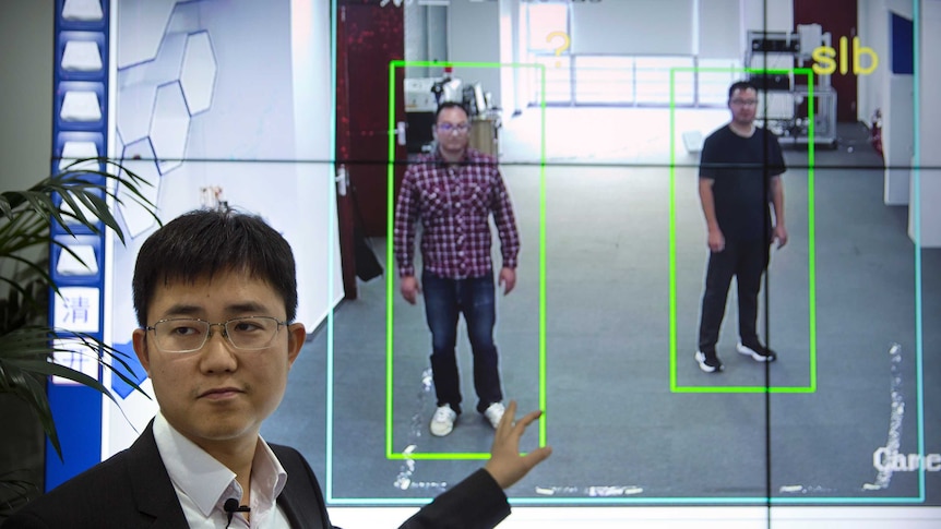 Huang Yongzhen, CEO of Watrix, demonstrates the use of his firm's gait recognition software at his company's offices in Beijing.