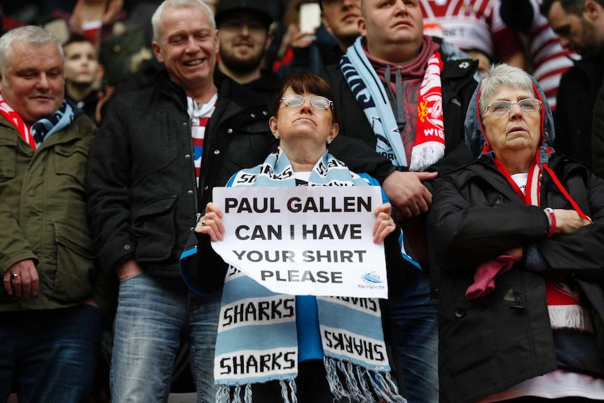 A lady holds up a sign for Paul Gallen