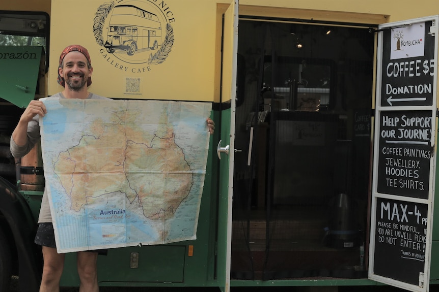 A man holding a map of Australia.