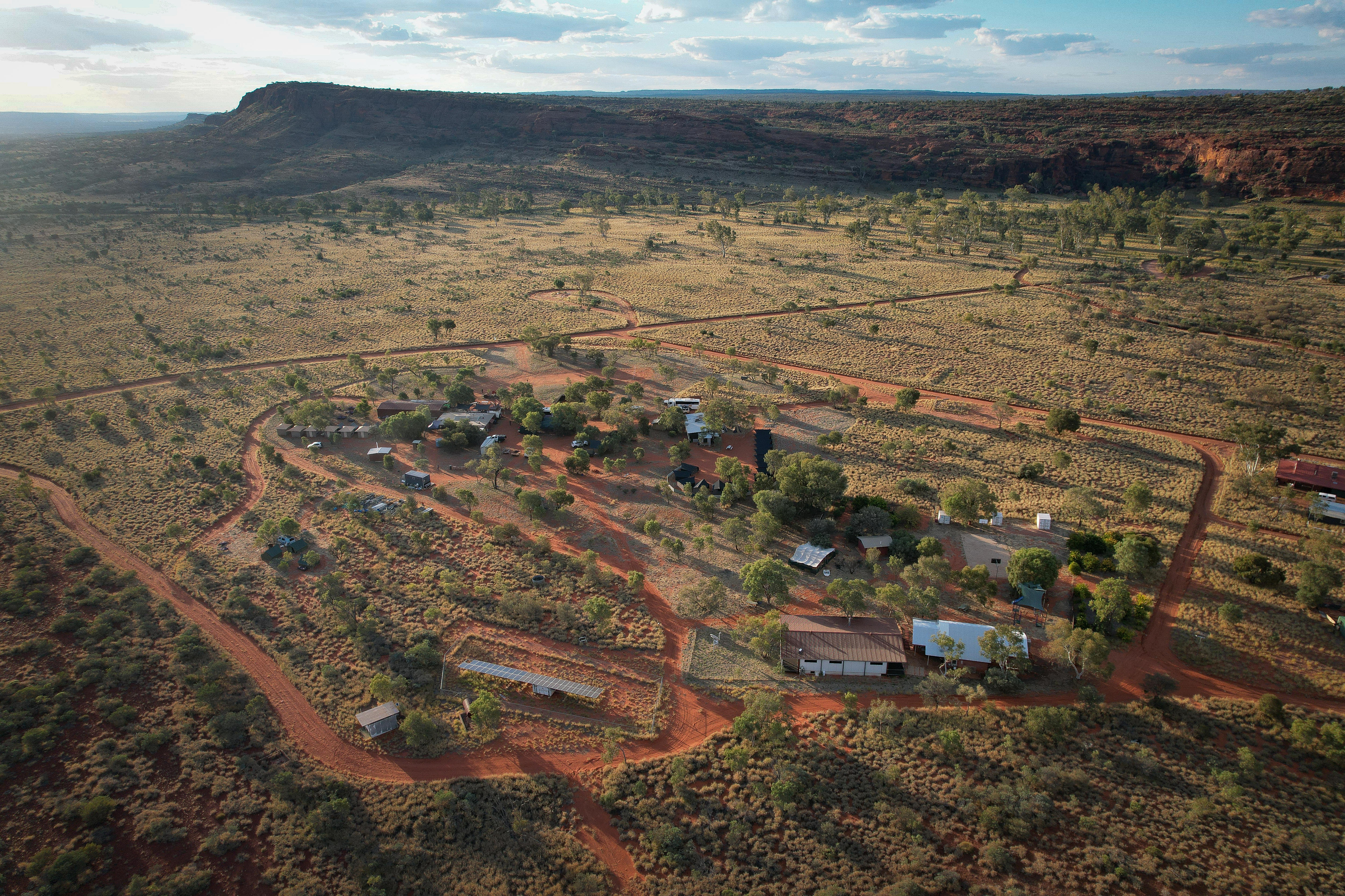 An aerial shot of a very small remote community with only a handful of buildings.