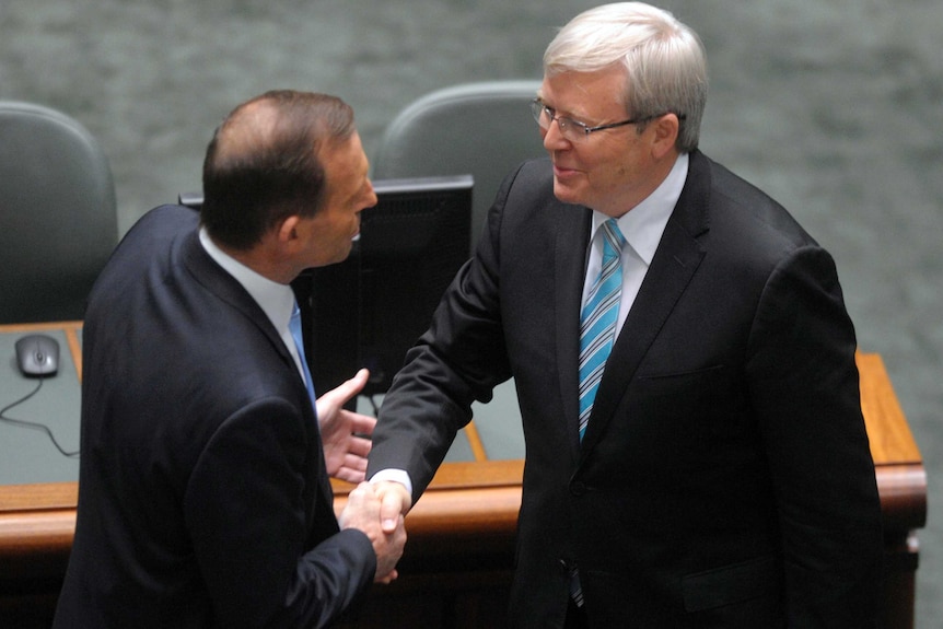 Tony Abbott shakes hands with Kevin Rudd.