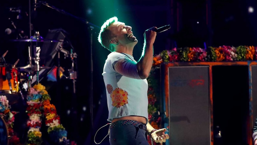 Coldplay perform on stage