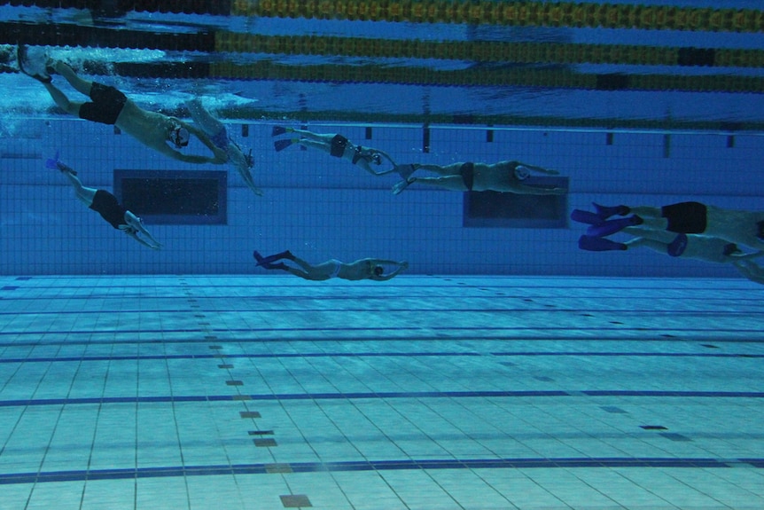 Multiple people can be seen swimming to the depths of a 3 metre pool.