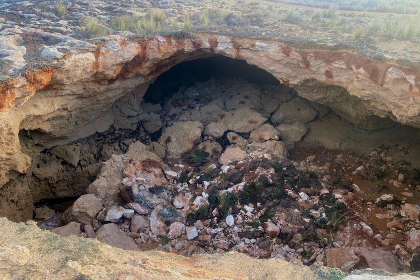 A hole in the ground along a coastline