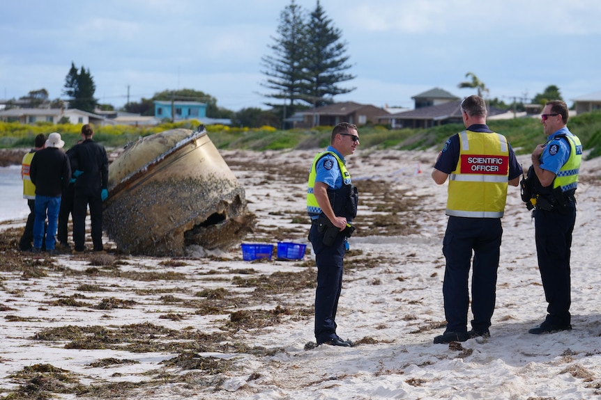 Police, Chemcentre Staff and others standing around the piece of space junk washed up at Green Head.