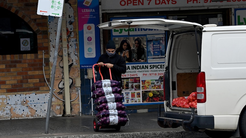 a man pushing a delivery trolley