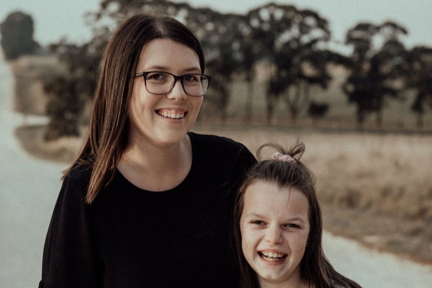 Mother and daughter with trees in the background