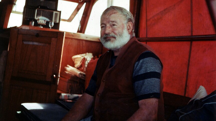 Ernest Hemingway in the cabin of his boat Pilar, off the coast of Cuba.