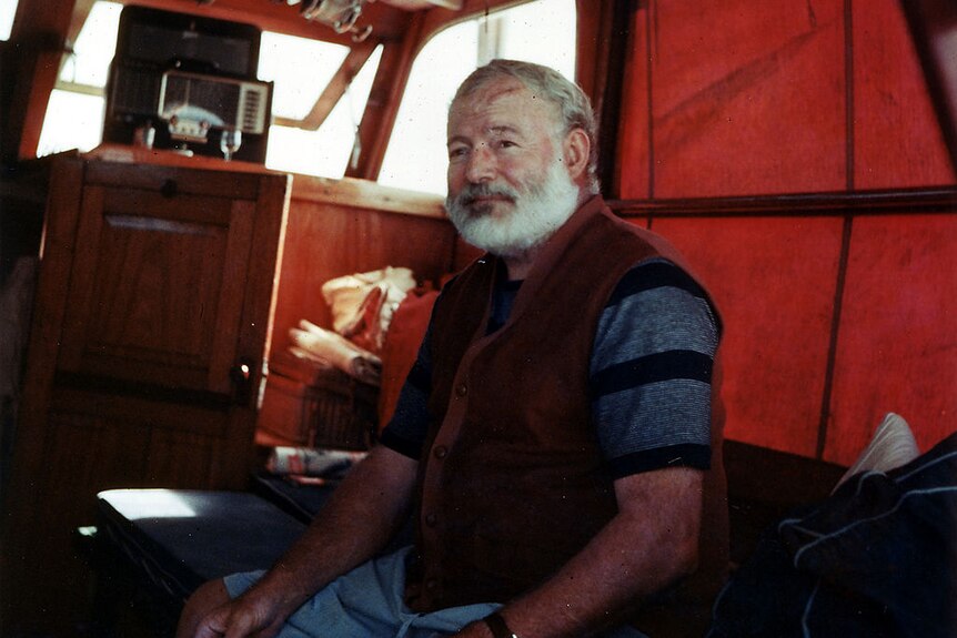Ernest Hemingway in the cabin of his boat Pilar, off the coast of Cuba.