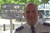 Southwark Safer Neighbourhoods officer Inspector Jim Cole with New Scotland Yard sign behind him