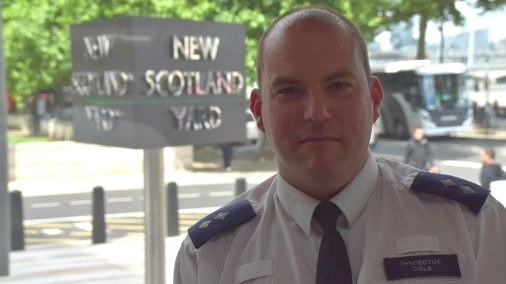 Southwark Safer Neighbourhoods officer Inspector Jim Cole with New Scotland Yard sign behind him