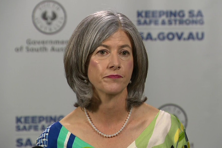 Nicola Spurrier in a green, blue and white striped top and a pearl necklace