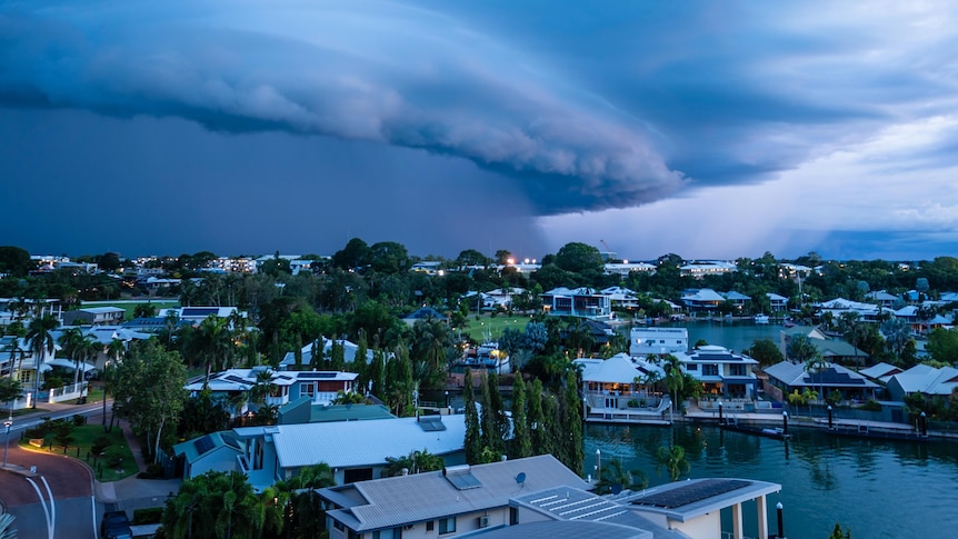 A menacing-looking storm looms over a city.