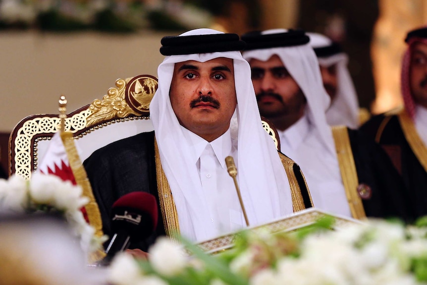 Qatar's Emir Sheikh Tamim bin Hamad Al-Thani looks at the camera.