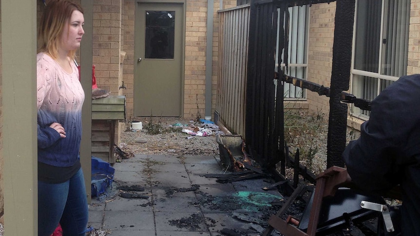 Tiarne Dooley inspects damage to her home at Hastings