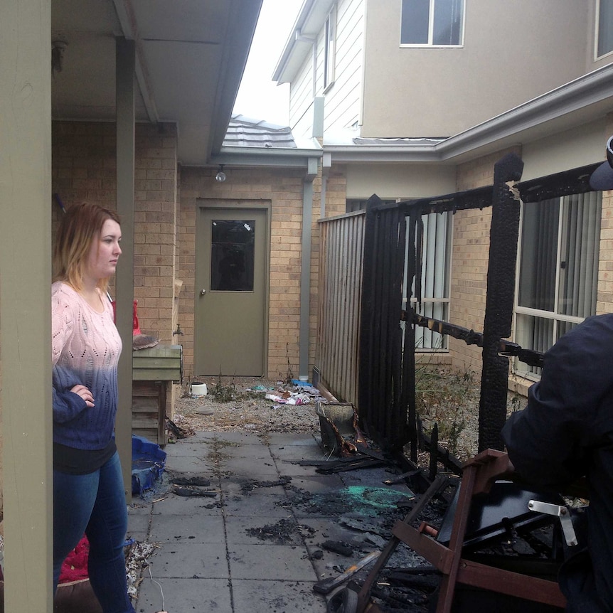 Tiarne Dooley inspects damage to her home at Hastings