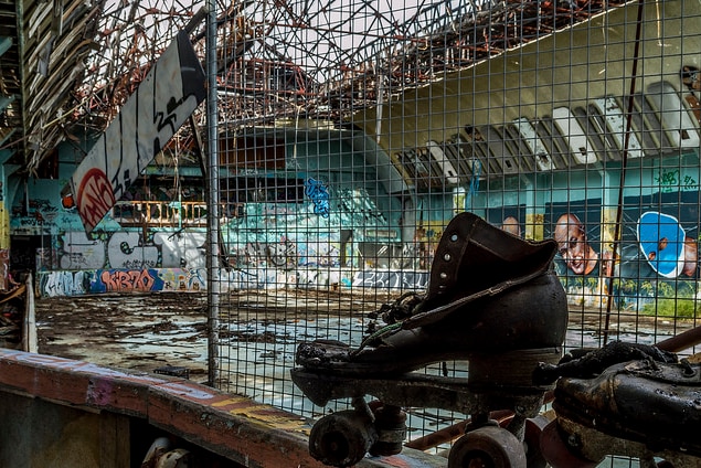 An old pair of skates in an old skate arena.