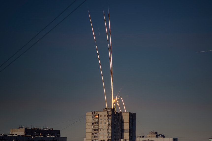 Rockets are seen at dawn streaking through the sky over Ukraine