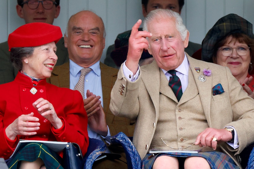 A man points while a woman smiles 