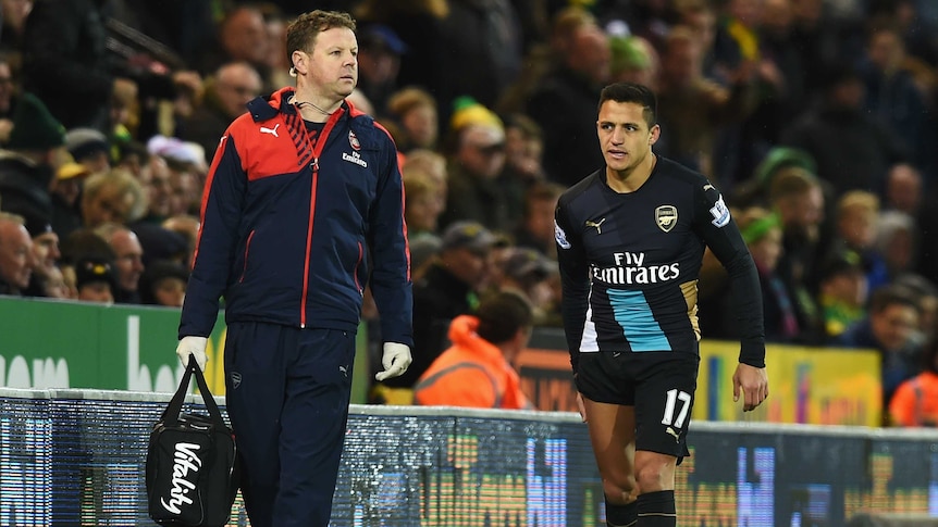 An injured Alexis Sanchez leaves the pitch in Arsenal's 1-1 draw with Norwich on November 29, 2015.